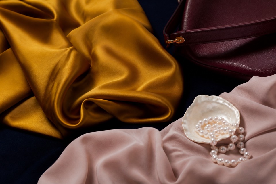 Mustard, burgundy, blush, and pearl editorial materials