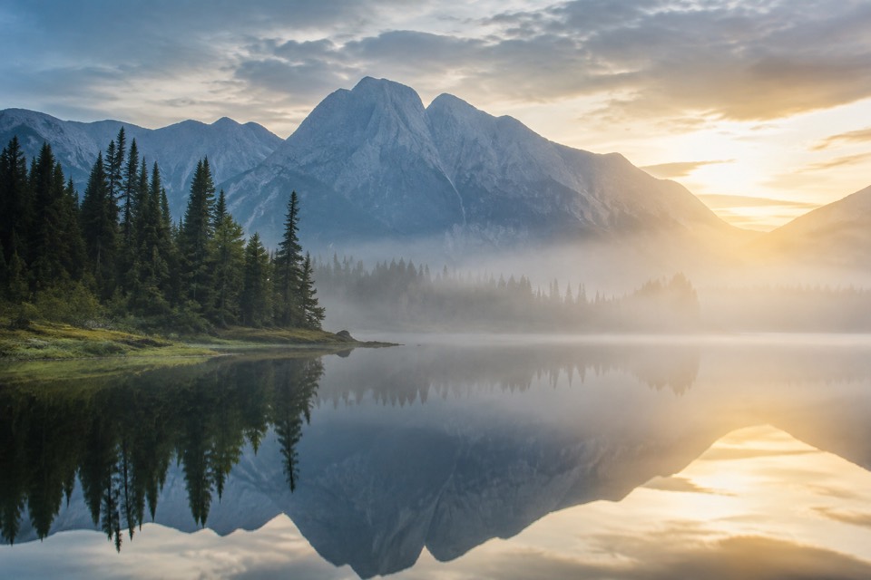Misty alpine lake at sunrise